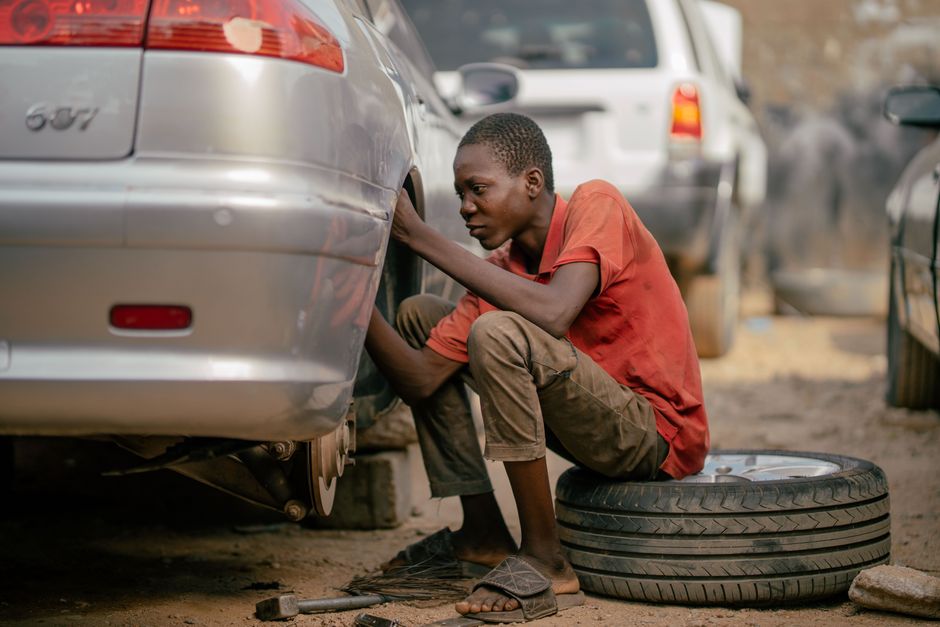 Mechanic replacing a tire on a vehicle